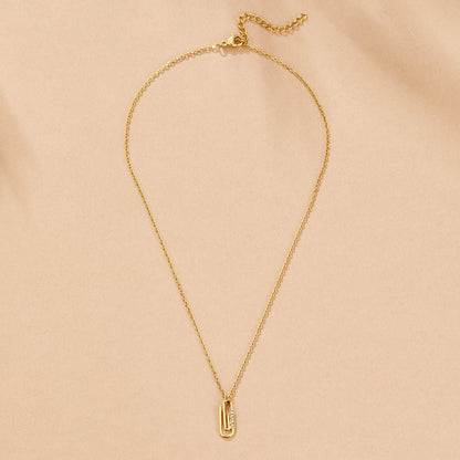 Collana con pendente a forma di graffetta in cristallo dorato